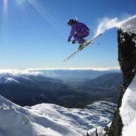 a man flying through the air on a snow covered mountain
