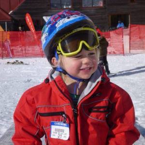 a boy wearing a snow helmet and goggles snow
