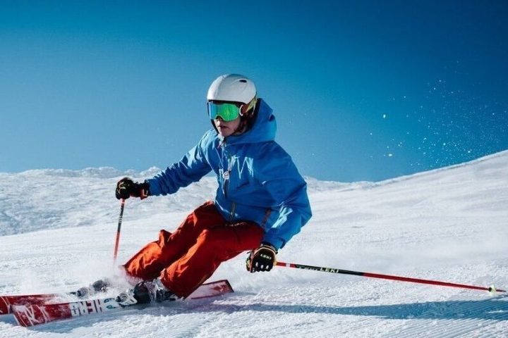 a man riding skis down a snow covered slope